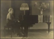 Portrait of a Woman Seated at the Piano, 1895-1907. Creator: Louis Fleckenstein