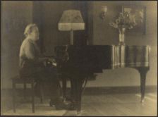 Portrait of a Woman Seated at the Piano, 1895-1907. Creator: Louis Fleckenstein
