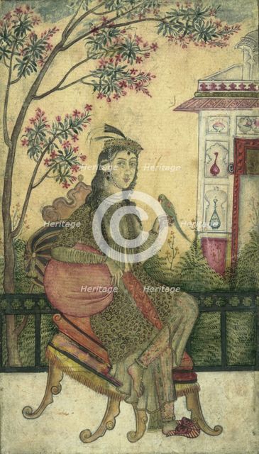 Portrait of a woman, seated, holding a small bird. Creator: Unknown.