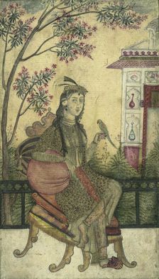 Portrait of a woman, seated, holding a small bird. Creator: Unknown