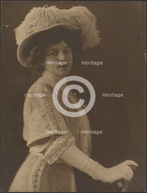 Portrait of a Woman Standing with Umbrella, 1907-1943. Creator: Louis Fleckenstein.