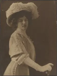 Portrait of a Woman Standing with Umbrella, 1907-1943. Creator: Louis Fleckenstein