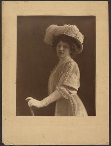 Portrait of a Woman Standing with Umbrella, 1907-1943. Creator: Louis Fleckenstein