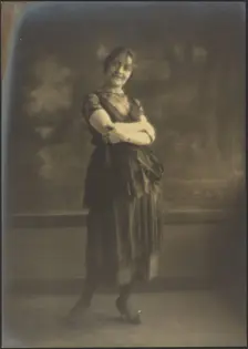 Portrait of a Woman Standing Before Tapestry, 1907-1943. Creator: Louis Fleckenstein