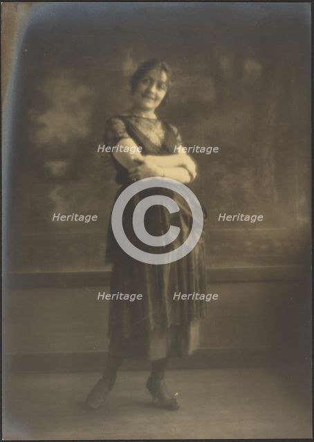 Portrait of a Woman Standing Before Tapestry, 1907-1943. Creator: Louis Fleckenstein.