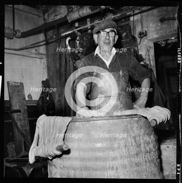Portrait of a worker in a factory involved in the processing of animal guts, 1966-1974. Creator: Eileen Deste.