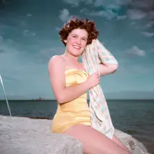 Portrait of a young woman in a swimsuit by the sea, c1955. Creator: Arthur Charles Kirby Ware