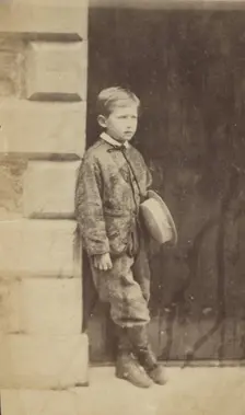 Portrait of a Young Boy in a Doorway, late 19th century. Creator: Unknown