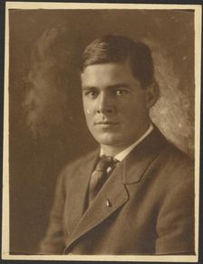 Portrait of a Young Man with Lapel Pin, 1907-1943. Creator: Louis Fleckenstein