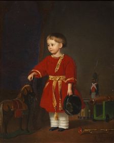 Portrait of a boy in a red dress with military toys