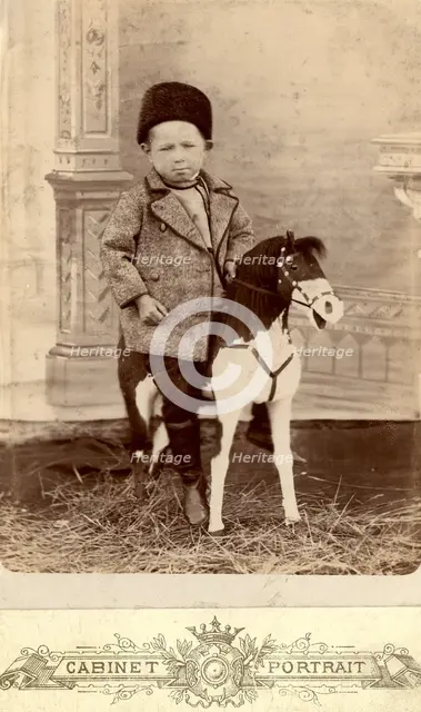 Portrait of a boy sitting on a toy horse, late 19th cent - early 20th cent. Creator: Unknown.