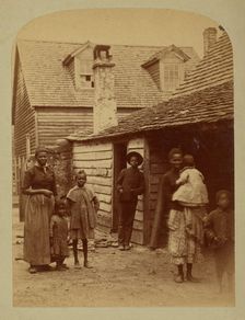 Portrait of a Black family standing in front of a house, 1886. Creator: George Barker
