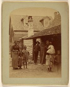 Portrait of a Black family standing in front of a house, 1886. Creator: George Barker