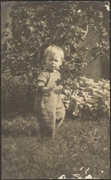 Portrait of a Child in Garden, 1907-1924. Creator: Louis Fleckenstein