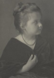 Portrait of a girl with a necklace clasping a shawl, c1900. Creator: Alice Austin