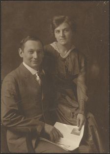 Portrait of a Man and a Woman Holding Magazine, 1907-1943. Creator: Louis Fleckenstein