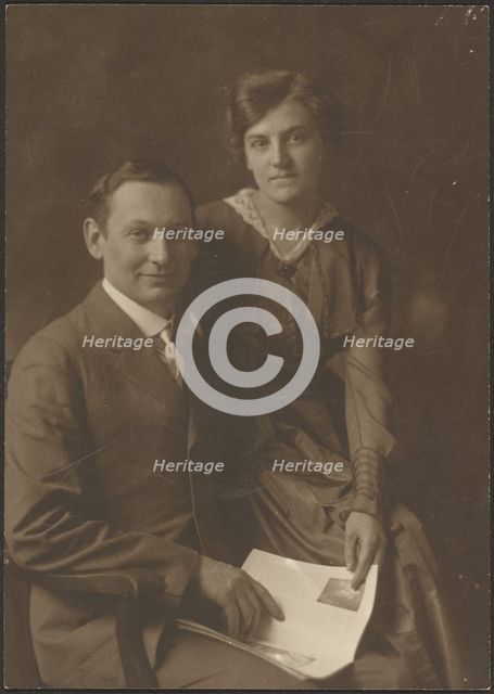 Portrait of a Man and a Woman Holding Magazine, 1907-1943. Creator: Louis Fleckenstein.