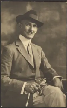 Portrait of a Man Holding Cane and Gloves, 1907-1943. Creator: Louis Fleckenstein