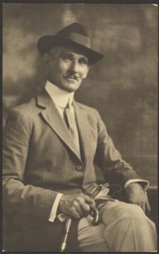 Portrait of a Man Holding Cane and Gloves, 1907-1943. Creator: Louis Fleckenstein