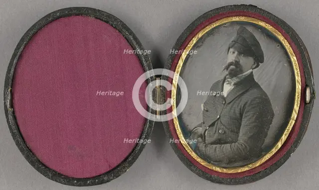 Portrait of a man with a busy moustache and goatee, wearing an angled cap, about 1850. Creator: Unknown.