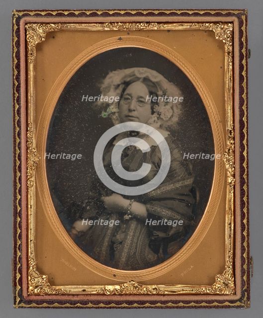Portrait of a middle-aged woman wearing wire-rimmed glasses in flower embellished veil, 1855-1860. Creator: James McClees.