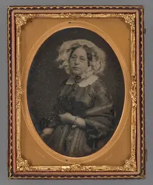 Portrait of a middle-aged woman wearing wire-rimmed glasses in flower embellished veil, 1855-1860. Creator: James McClees