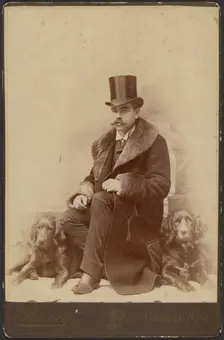 Portrait of a Moustachioed Seated Man in Top Hat and Winter, Fur-Collared Coat..., about 1890. Creator: Lewis Peavey