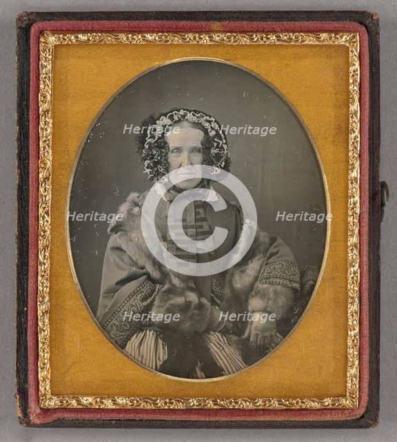 Portrait of an elderly woman wearing a hat, fur coat and gloves, seated, about 1855. Creator: Unknown.