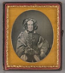 Portrait of an elderly woman wearing a hat, fur coat and gloves, seated, about 1855. Creator: Unknown