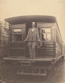 Portrait of an unidentified man standing on rear platform of a train, about 1863. Creator: Unknown