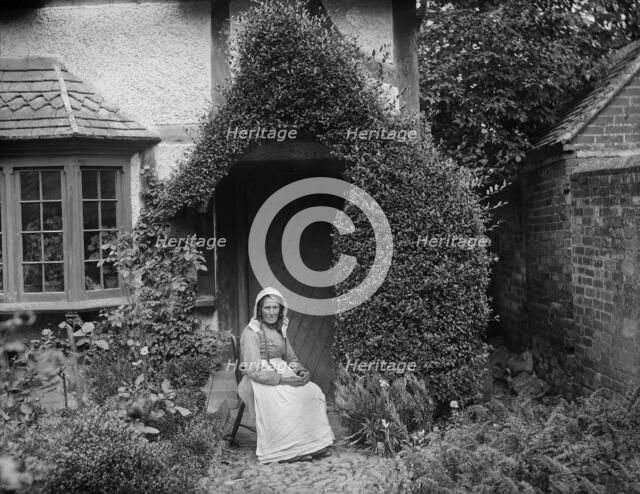 Portrait of an unknown elderly woman sitting outside her cottage, West Ilsley, West Berkshire, 1900. Creator: Henry Taunt.