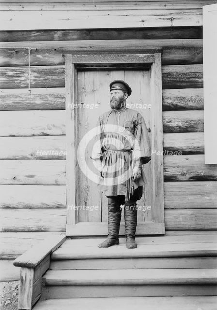 Portrait of an unknown man on the porch of a wooden house, 1900. Creators: I. A. Podgorbunskii, V. I. Podgorbunskii.