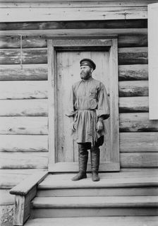 Portrait of an unknown man on the porch of a wooden house, 1900. Creators: I. A. Podgorbunskii, V. I. Podgorbunskii