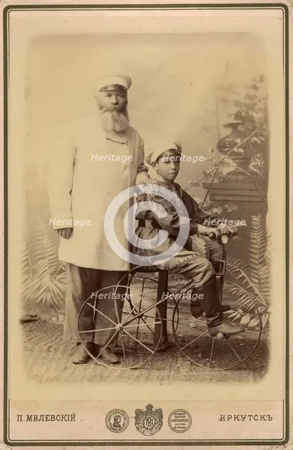 Portrait of an unknown man with a boy sitting on a bicycle, end of 19th century. Creator: PA Milevskii.