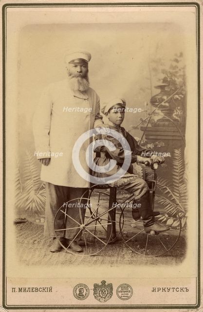 Portrait of an unknown man with a boy sitting on a bicycle, end of 19th century. Creator: PA Milevskii.