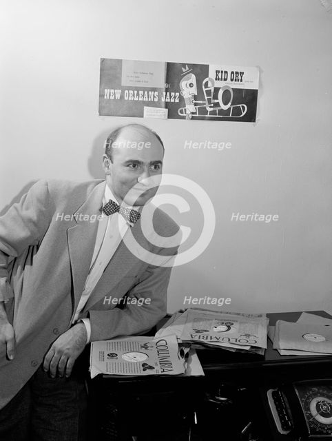 Portrait of George Avakian in his office or home, New York, N.Y.(?), 1938. Creator: William Paul Gottlieb.