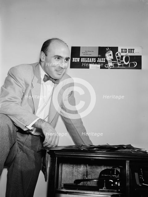 Portrait of George Avakian in his office or home, New York, N.Y.(?), 1938. Creator: William Paul Gottlieb.
