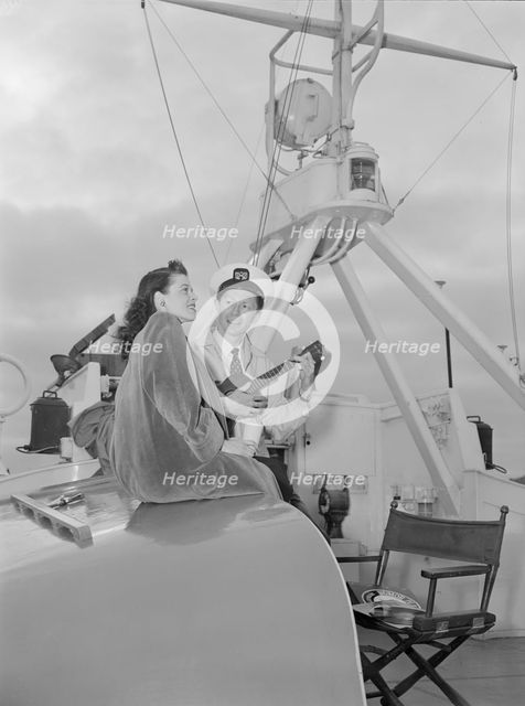 Portrait of Frank Raye and Betty Brewer, Ukelele Lady (yacht), Hudson River, N.Y., ca. June 1947. Creator: William Paul Gottlieb.