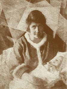Portrait of Liubov Popova with her son in her studio, 1919. Creator: Anon