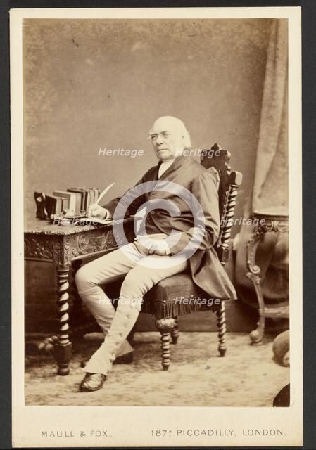 Portrait of man holding quill, about 1879-1885. Creator: Maull & Fox.