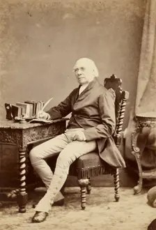 Portrait of man holding quill, about 1879-1885. Creator: Maull & Fox