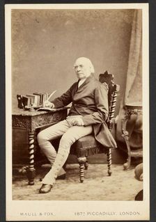 Portrait of man holding quill, about 1879-1885. Creator: Maull & Fox