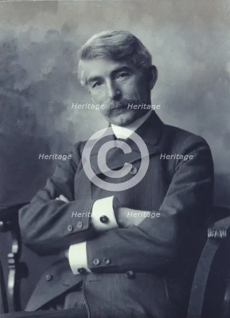Portrait of man wearing a pinstripe suit seated with his arms crossed, c1900. Creator: Fannie L. Elton.