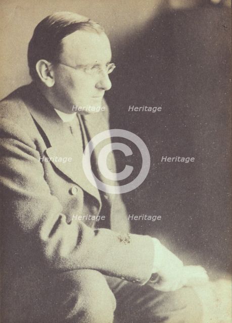 Portrait of man wearing glasses, seated with elbow resting on right knee , c1900. Creator: Eva Watson-Schutze.