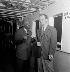 Portrait of Rudi Blesh and Baby Dodds, Riverboat on the Hudson, N.Y., ca. July 1947. Creator: William Paul Gottlieb