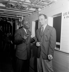 Portrait of Rudi Blesh and Baby Dodds, Riverboat on the Hudson, N.Y., ca. July 1947. Creator: William Paul Gottlieb