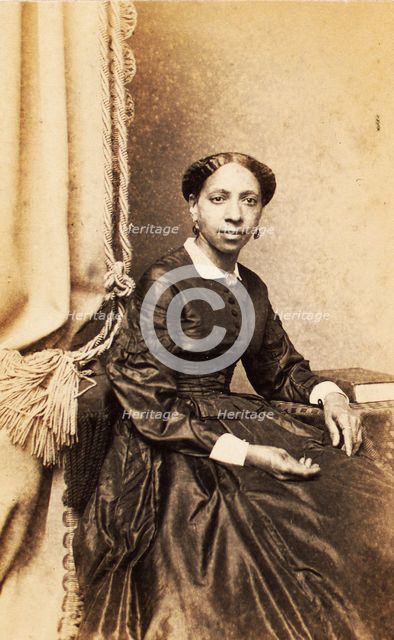 Portrait of woman seated next to tasselled curtain, (1860-1880?). Creator: Abraham Bogardus.
