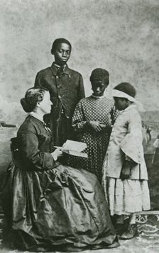 Portrait of teacher Laura M. Towne, a founder of the Penn School, with students..., February 1866. Creator: Unknown