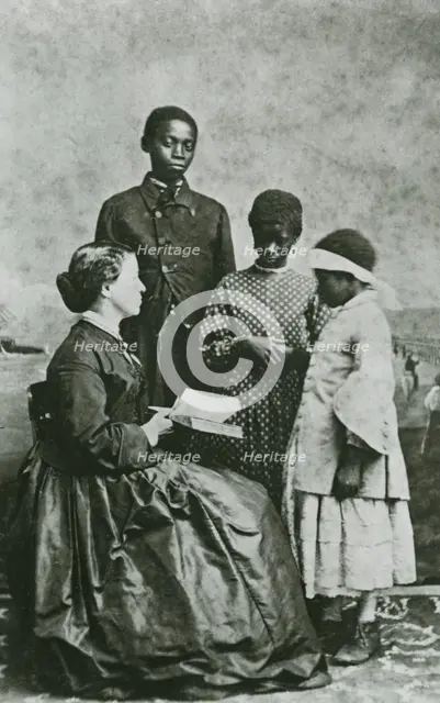 Portrait of teacher Laura M. Towne, a founder of the Penn School, with students..., February 1866. Creator: Unknown.
