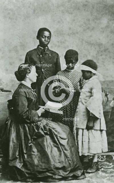 Portrait of teacher Laura M. Towne, a founder of the Penn School, with students..., February 1866. Creator: Unknown.